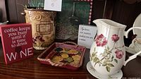 group shot showing pitcher, grape container, tray, block signs and plaque