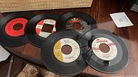 Five sample 45 RPM singles from Columbia, Laurie, Chancellor, Jamie, Swan labels