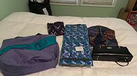 All five items laid out on bed