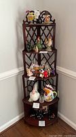 Full view of mahogany corner étagère showing five shelves and lattice sides