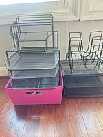 Overall view of both black metal organizers stacked with fuchsia bin underneath