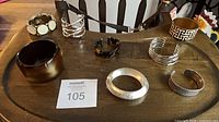 All eight bracelets laid out on table for full lot view