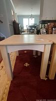 Front view of one side table showing legs, apron, finish