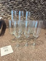 ten clear glass stemware pieces standing on countertop