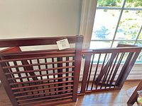 overall view of two solid wood gate panels showing slat design and finish