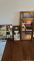Group shot of mirror and two canvas prints leaning against wall
