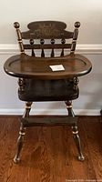 Full front view showing entire high chair with tray and legs