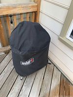Grill on deck fitted with Weber logo cover