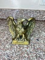 Front view of brass eagle bookend with 1776 on base