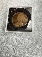 Obverse of 1875 Great Britain penny in holder