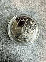 Obverse showing Lake Louise / Mt. Assiniboine design inside capsule