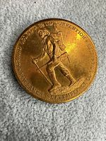 Obverse of medal showing prospector figure and convention text