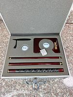 Open aluminum case showing all components neatly in foam