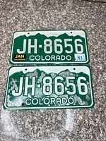 Front view both Colorado plates showing number, decals, paint loss