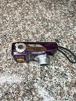 Top view of Kodak EasyShare C182 showing power dial, lens retracted, purple body