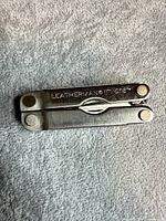 Folded Leatherman Micra showing branding on handle