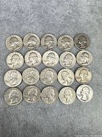 20 Washington silver quarters arranged in 4×5 grid obverse side up