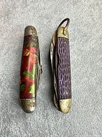 Two closed pocket knives side by side showing handle materials and bolsters