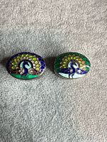 Top view of both enamel peacock pill boxes