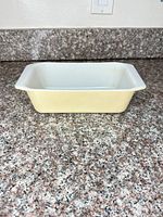 Side view of yellow Pyrex loaf pan