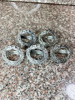All five pewter wreath napkin rings group view