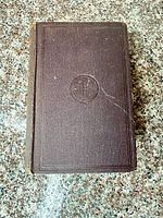 Front cover showing brown textured cloth with blind-stamped design