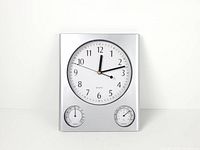 front view of square silver wall clock with main dial and two sub-dials
