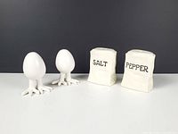 Full set showing two egg shakers with feet and two paper bag shakers