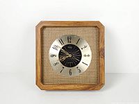 Front view of square wood clock showing dial and cane backing