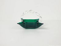 Front view showing emerald green basket and clear twisted handle