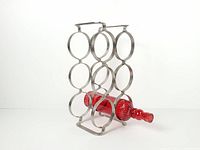 Full view of metal wine rack with one bottle inserted