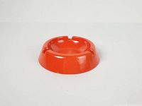 top and side view of orange melamine ashtray showing overall shape
