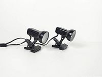 pair of black metal clamp-on spotlights front view