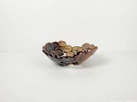 Side profile of hand-built coil bowl showing earth-tone glaze
