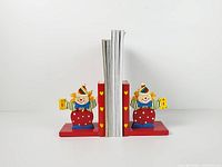 Front view of both clown bookends supporting books