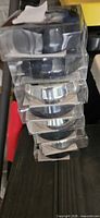 Stack of eight packaged round LED puck lights