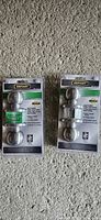Front view of two sealed Defiant satin nickel privacy door knob packages
