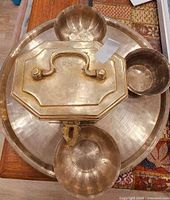 Top view showing round brass tray, lidded box and three bowls