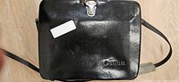 Exterior of black leather Canon case with clasp and strap