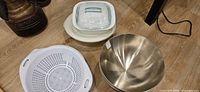 Group view showing colander, Pyrex dish, white bowls and stainless steel bowls