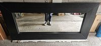 Front view of Mongstad mirror showing frame and glass
