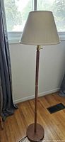Full view of teak floor lamp with shade
