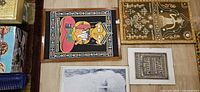 Group view of all three framed paintings laid out