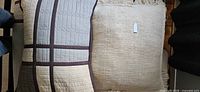 two decorative pillows, showing designs and textures