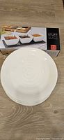 Stack of five white dinner plates and boxed Stuff of Slate dip bowl set