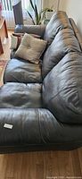 Side/angle view of sofa showing leather texture and seat depth