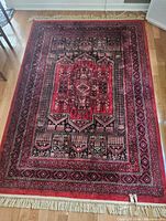 Full view of silk rug showing entire pattern, colours and fringe