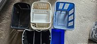 Top view of six assorted storage containers laid out on floor