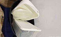 Black oval tub containing clear bin and white file holders