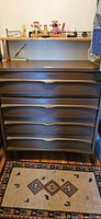 Front view showing entire dresser with four drawers and top surface